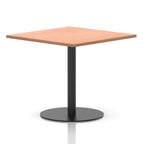 Square table with a wood-effect top and black cylindrical base on a white background