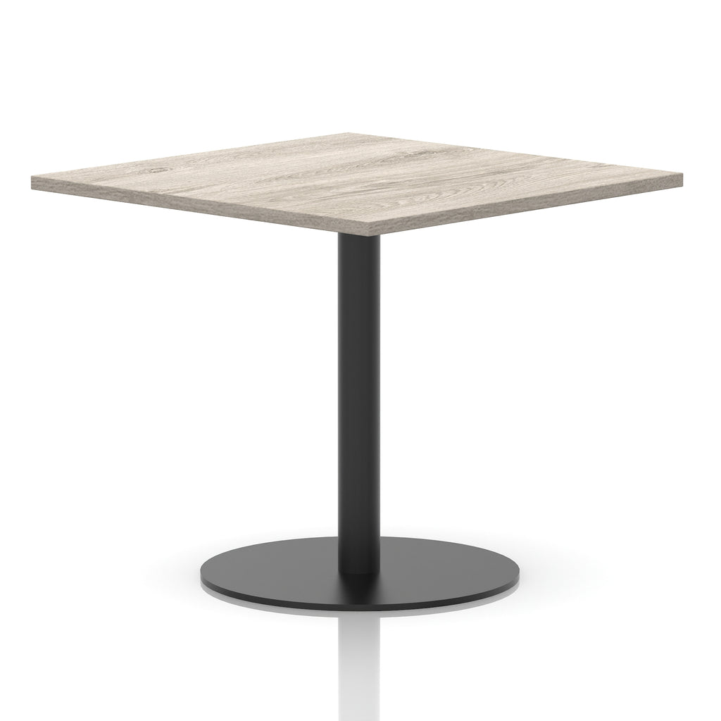 Square table with a grey wood-effect top and black cylindrical base on a white background