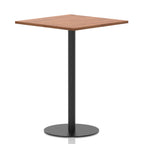 Square table with a wood-effect top and black cylindrical base on a white background