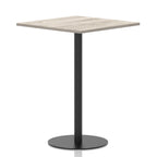 Square table with a grey wood-effect top and black cylindrical base on a white background