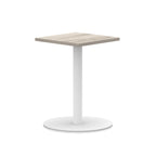 Square table with wood-effect top and white round base on a white background