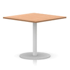 Square table with wood-effect top and white round base on a white background