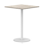 Square table with wood-effect top and white round base on a white background