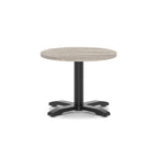 Round coffee table with grey wood-effect top and black metal base on a white background