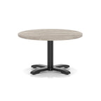 Round coffee table with grey wood-effect top and black metal base on a white background