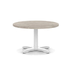 Round coffee table with grey wood-effect top and white metal base on a white background