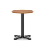 Round high table with a wood-effect top and black base on a white background