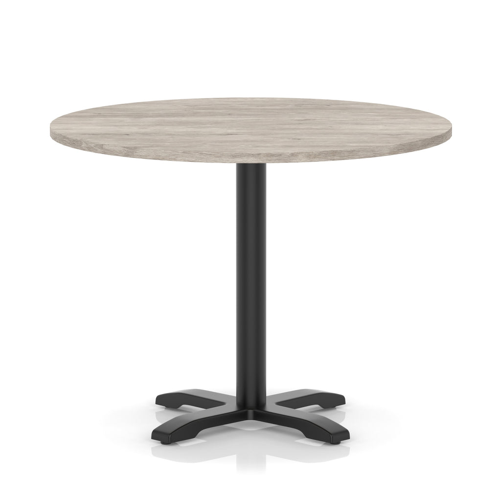 Round table with a grey wood-effect top and black base on a white background