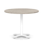 Round table with grey wood-effect top and white base on a white background