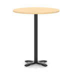 Round high table with a wood-effect top and black base on a white background