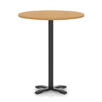 Round high table with a wood-effect top and black base on a white background