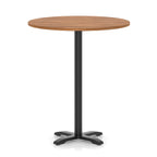 Round high table with a wood-effect top and black base on a white background