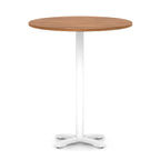 Round high table with wood-effect top and white base on a white background