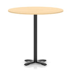 Round high table with a wood-effect top and black base on a white background