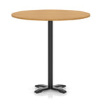 Round high table with a wood-effect top and black base on a white background