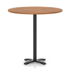 Round high table with a wood-effect top and black base on a white background