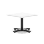 A square cafe table with a white top and a black pedestal base with four legs, shown on a clean white background.