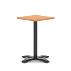 Square table with grey wood-effect top and black metal base on a white background