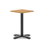 Square table with wood-effect top and black metal base on a white background