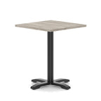 Square table with grey wood-effect top and black metal base on a white background