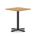 Square table with wood-effect top and black metal base on a white background