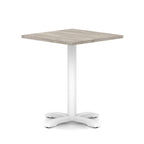 Square table with grey wood-effect top and white metal base on a white background