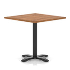 Square table with wood-effect top and black metal base on a white background