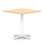 Square table with wood-effect top and white metal base on a white background