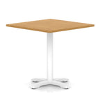Square table with wood-effect top and white metal base on a white background