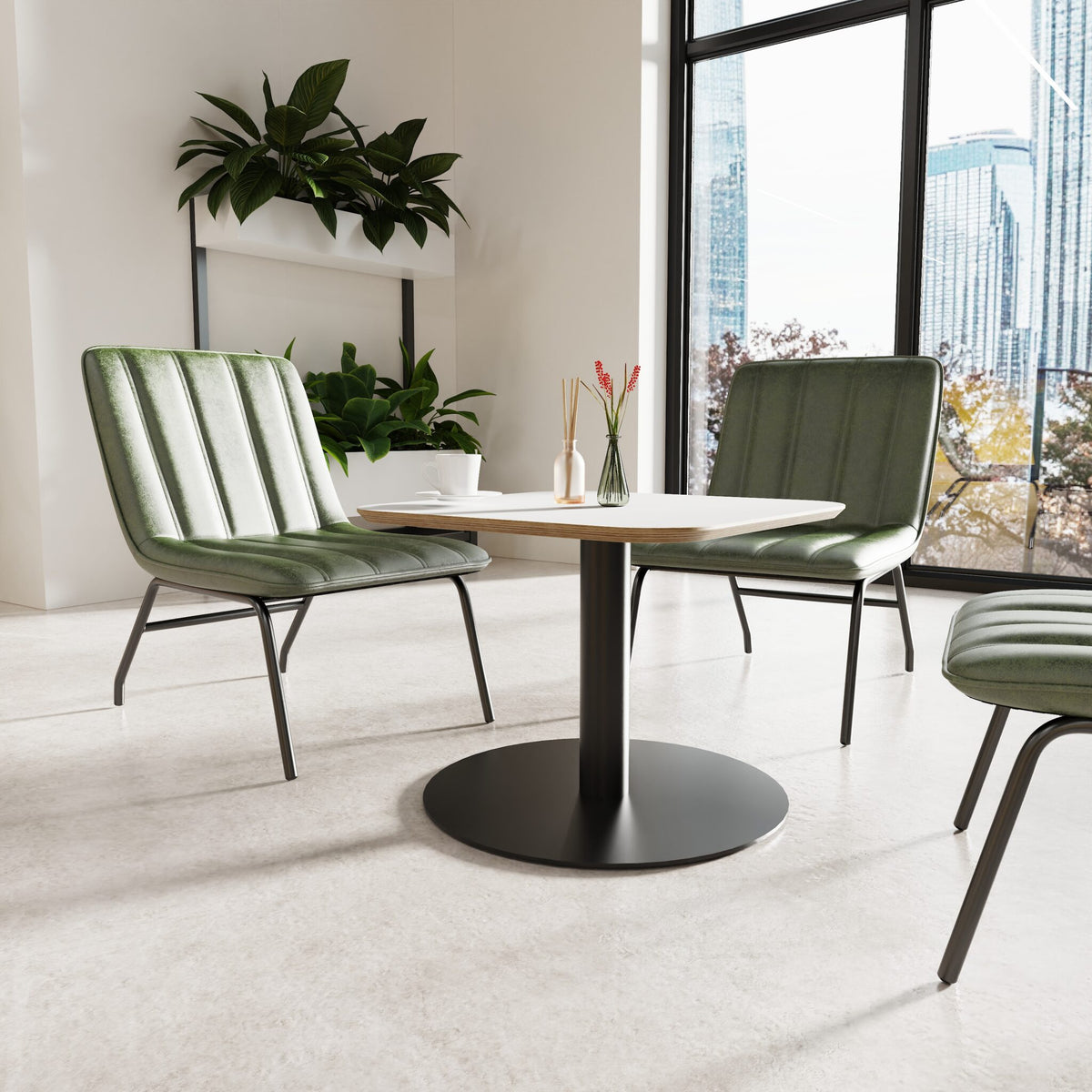 Modern green chairs around a round table in a bright room with large windows.