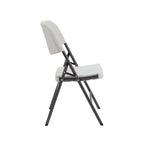 White folding chair with black legs on a white background