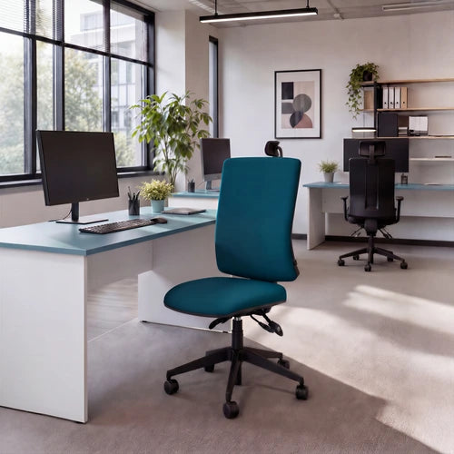 A modern office environment featuring a teal fabric office chair with a black wheeled base in the foreground, set against white desks with light blue tops and other office furniture in the background.