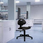 Black office chair in a laboratory setting with white cabinets and blue flooring.