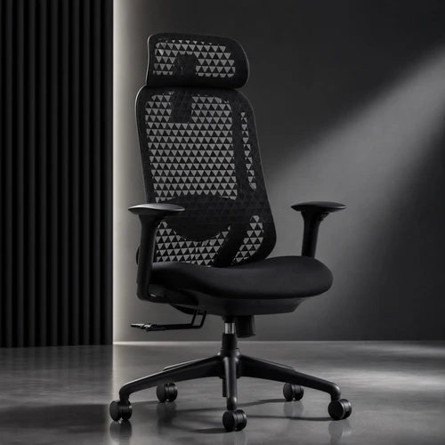A black mesh ergonomic office chair with a high back, triangular patterned backrest, adjustable armrests, and a five-wheel base, set against a dark gray studio background with dramatic lighting.