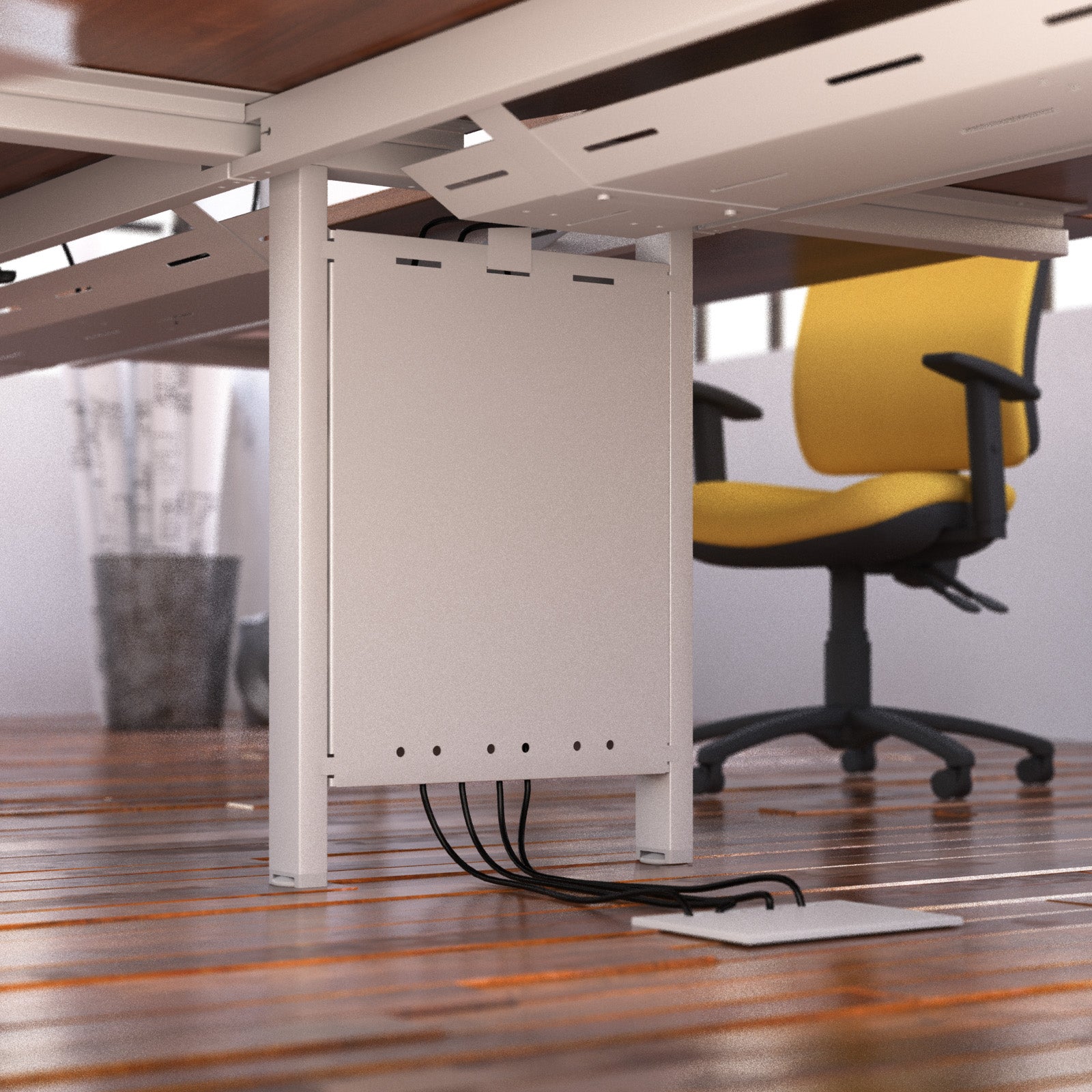 Under-desk cable management system with a yellow office chair in the background.