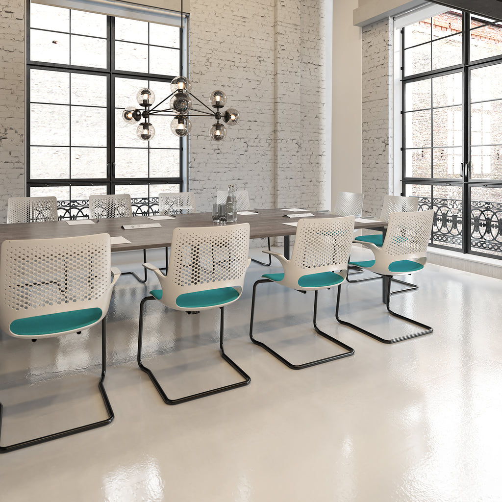 Modern office meeting room with white chairs and a chandelier.