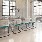 Modern office meeting room with white chairs and a chandelier.