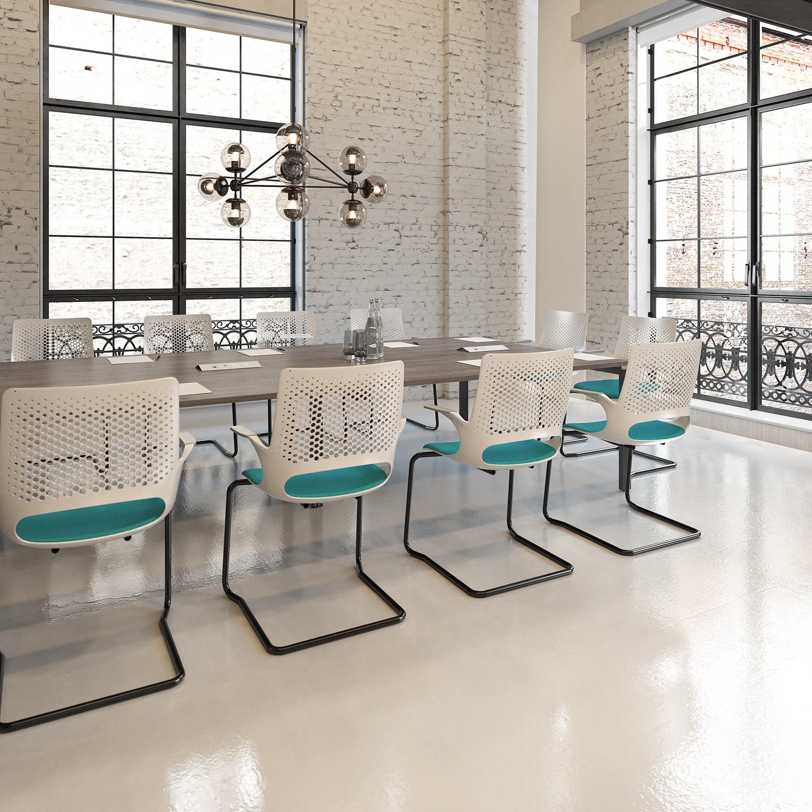 Modern office meeting room with white chairs and a chandelier.