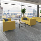 Modern office lounge with yellow sofas, a coffee table, and city view.