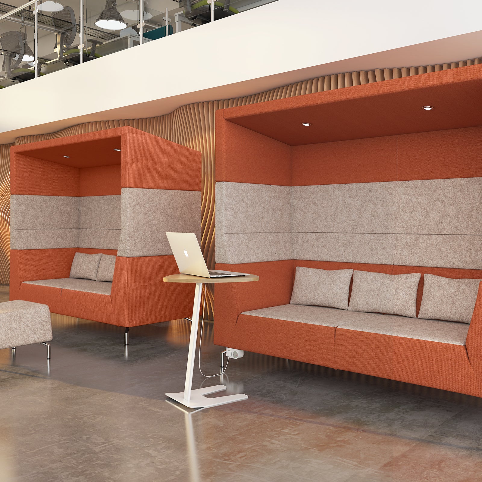 Modern office lounge with orange and grey seating area and a standing desk.