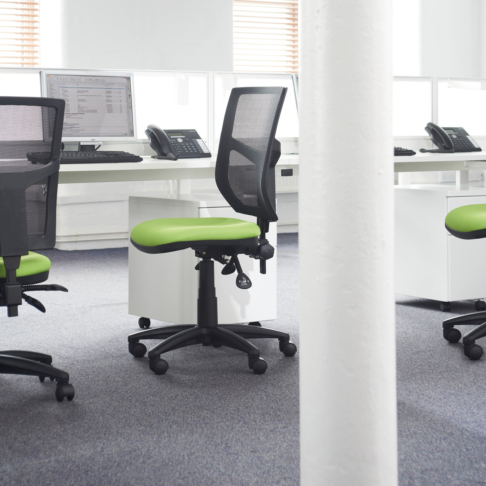 Modern office setup with ergonomic chairs and desks.