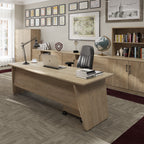Wooden office desk with a chair, laptop, and decor in an office setting.