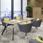 A modern meeting room setup featuring a rectangular wooden conference table with black metal legs, surrounded by six gray swivel chairs with yellow accent pillows. The room has a large window overlooking a city skyline, a potted tree, and a wooden cabinet in the background.