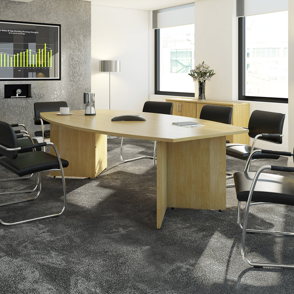 Modern office conference room with a large wooden table and chairs.
