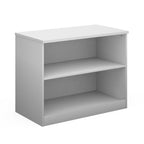 A two-tier bookcase in white, shown from a three-quarter angle on a solid white background.