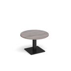 A modern round coffee table with a grey wood-effect top and a square black pedestal base, shown on a plain white background.