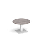 A modern round coffee table with a grey wood-effect top and a square white pedestal base, shown on a plain white background.