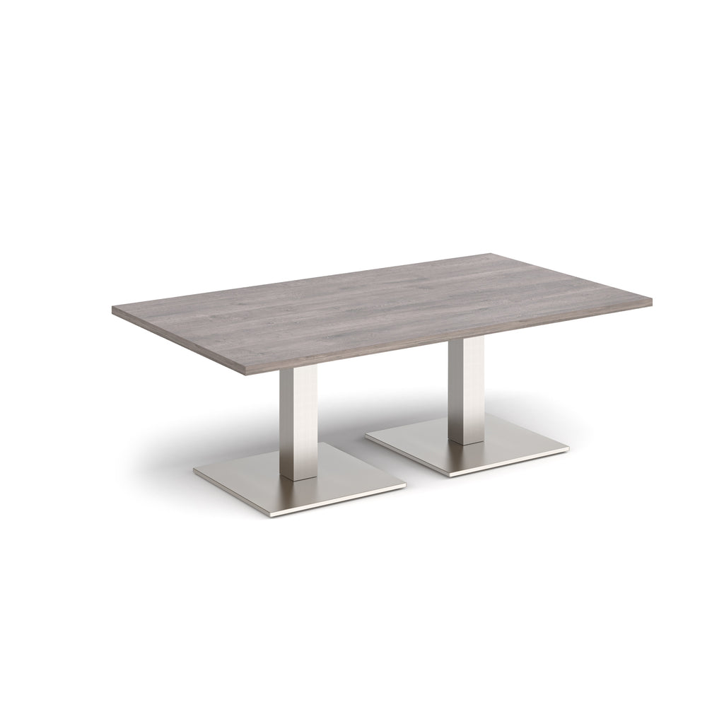 Rectangular coffee table with grey wood-effect top and two brushed steel metal square bases, shown on a white background