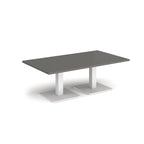 Rectangular coffee table with grey top and two white metal square bases, shown on a white background