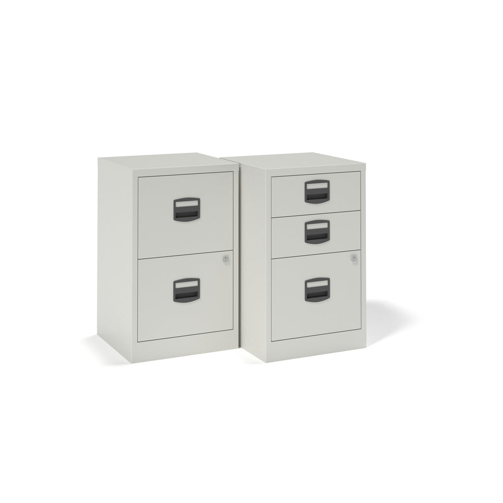 Two light grey metal filing cabinets on a white background, one with two drawers and one with three drawers.